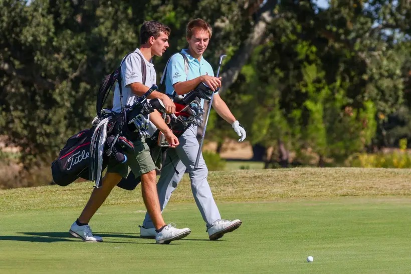 Two golfers walking the fairway